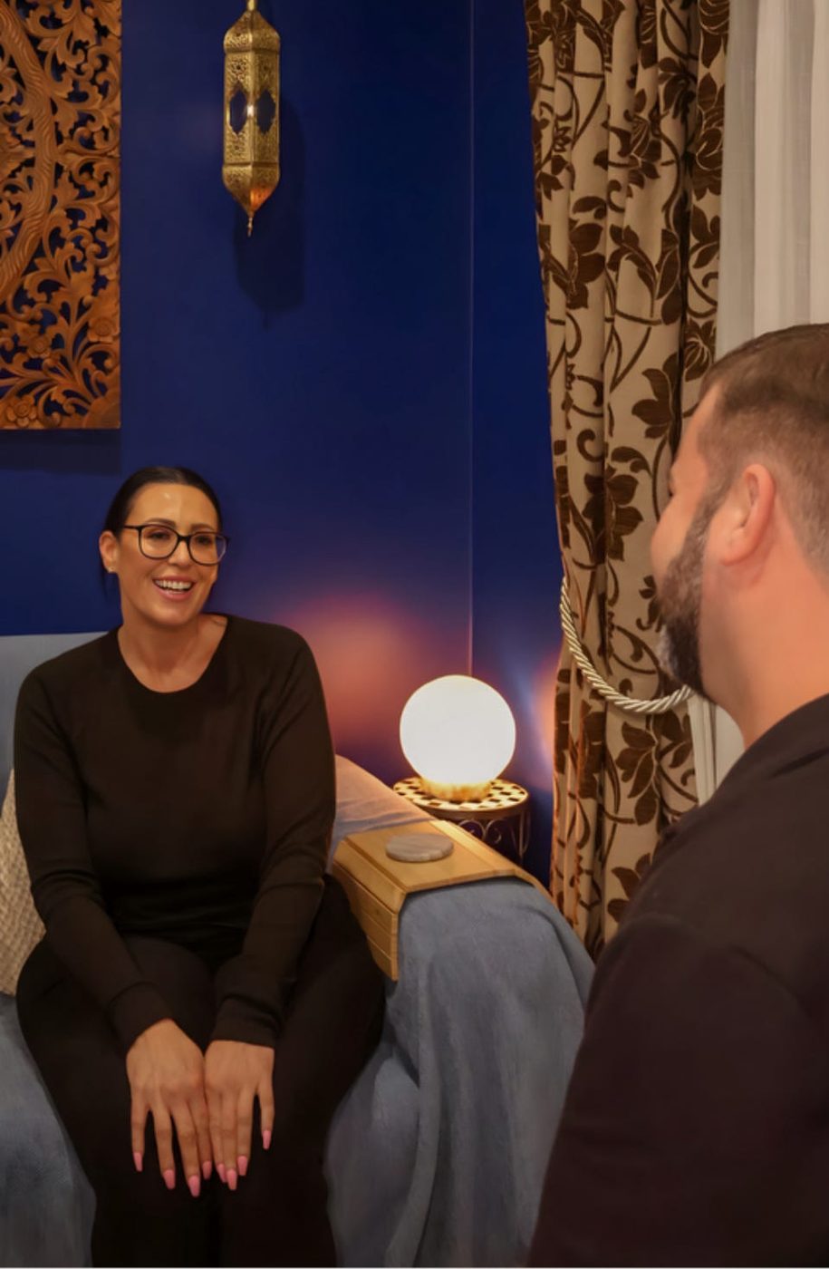 Mathew talking with a client in the studio before her session